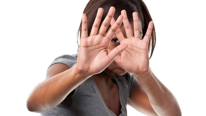 Young Woman Hiding Face With Hands