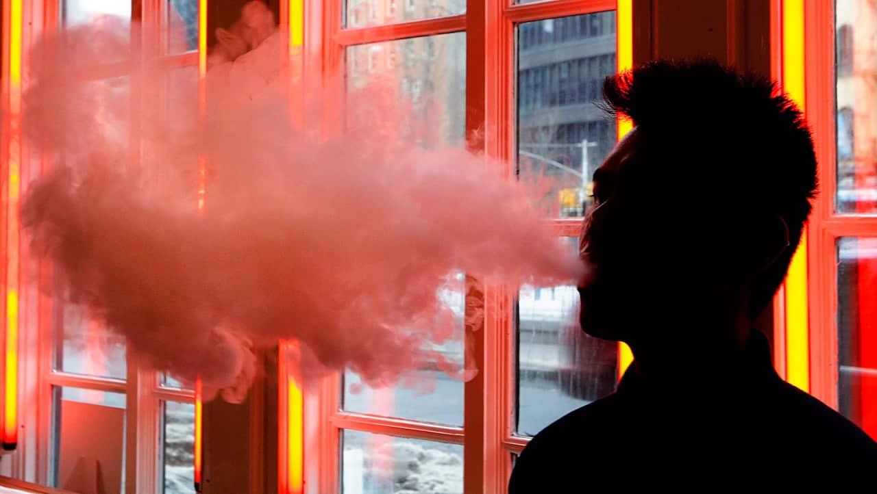 A patron exhales vapor from an e-cigarette at the Henley Vaporium in New York