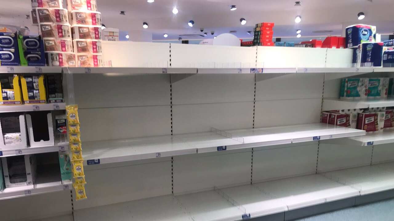 Supermarket shelves empty of toilet paper