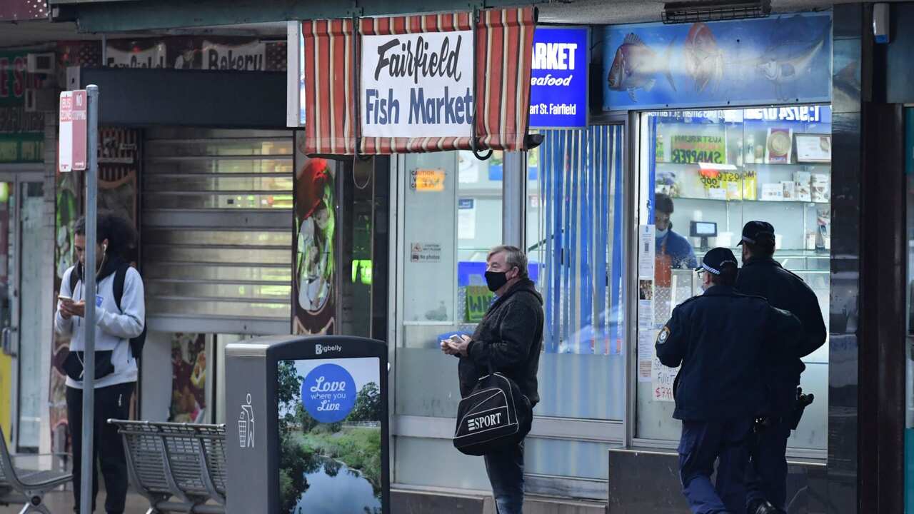 Police are walking in the shopping district in the southwestern suburb of Fairfield in Sydney