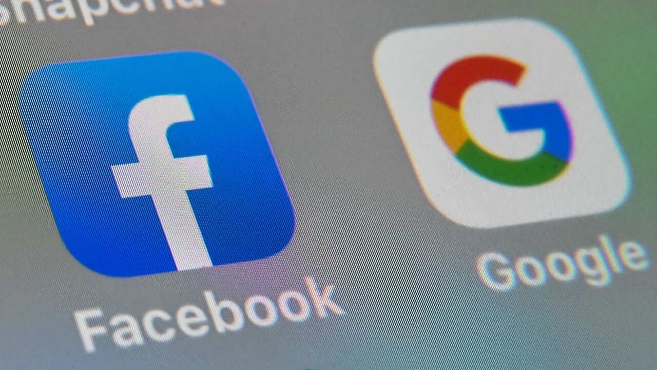 A picture taken on October 1, 2019 in Lille shows the logos of mobile apps Facebook and Google displayed on a tablet
