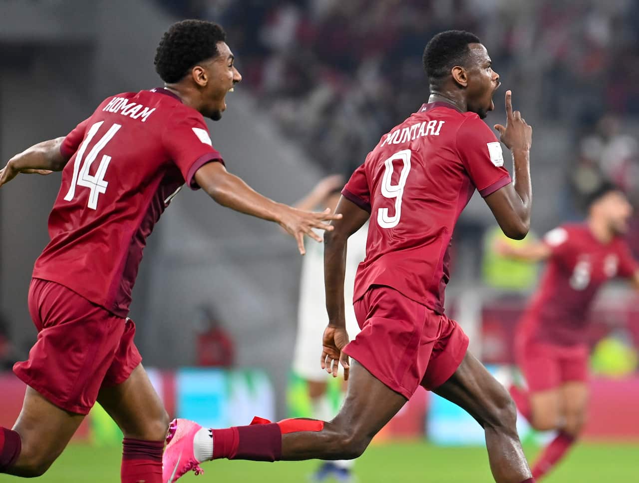 Mohammed Muntari (R) of Qatar celebrates after scoring during the FIFA Arab Cup 2021 semi final soccer match between Qatar and Algeria at Al Thumama Stadium in Doha, Qatar, 15 December 2021.  EPA/NOUSHAD THEKKAYIL