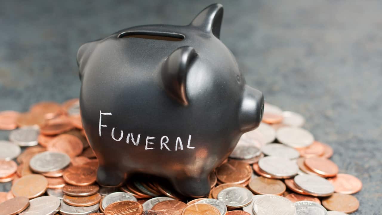 A Family member, wearing a Personal Protective Equipment (PPE), performs the last rites for COVID-19 victims at a cremation ground in New Delhi, India, 29 April 2021. 