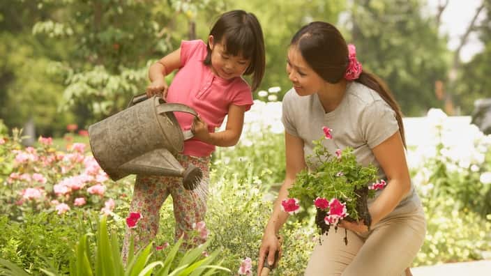 Asian mother and young daughter gardening
