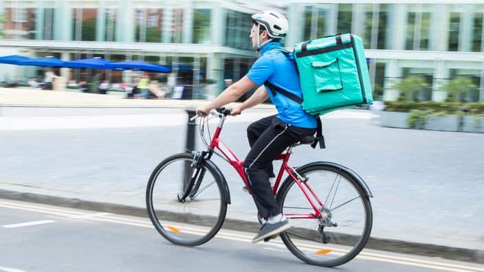 Courier on bicycle delivering food in the city