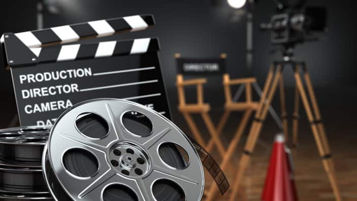 Video, movie, cinema concept. Retro camera, reels, clapperboard