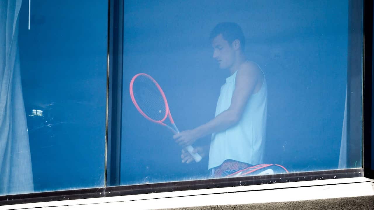 Australian tennis player Bernard Tomic exercises in his hotel room in Melbourne in January 17, 2021, as players quarantine in hotels ahead of the Australian Open tennis tournament. 