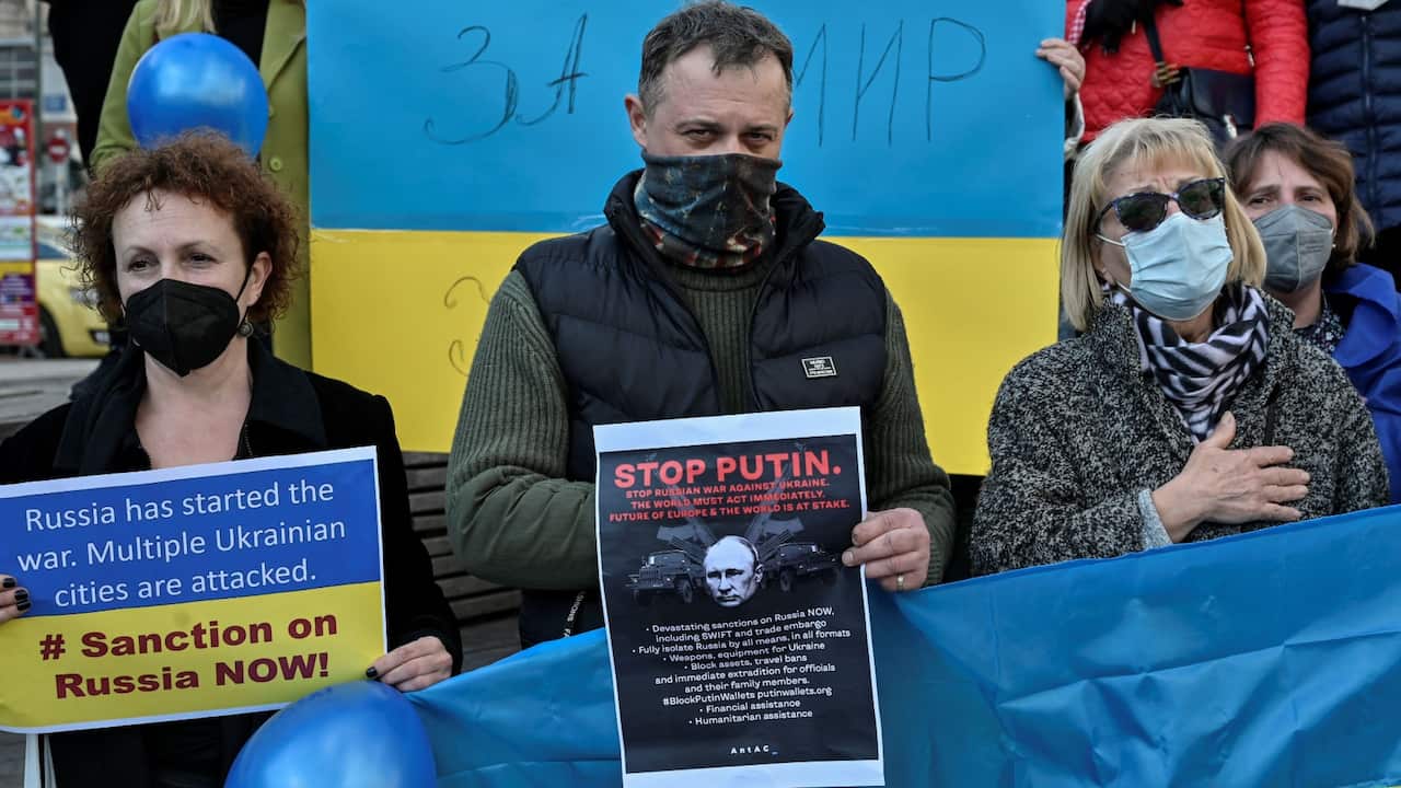 Ukrainians living in Greece sing their national anthem in central Athens after Russia launched attack on Ukraine, on February 24, 2022 