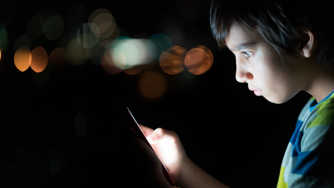 Kid with a mobile phone/cpmputer