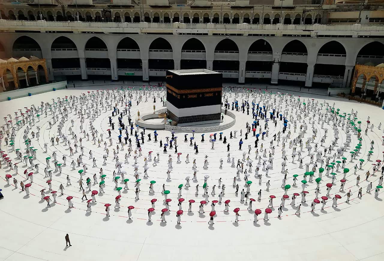 Hundreds of Muslim pilgrims circumambulate around the Kaaba, the cubic building at the Grand Mosque, as they keep social destination to protect themselves.