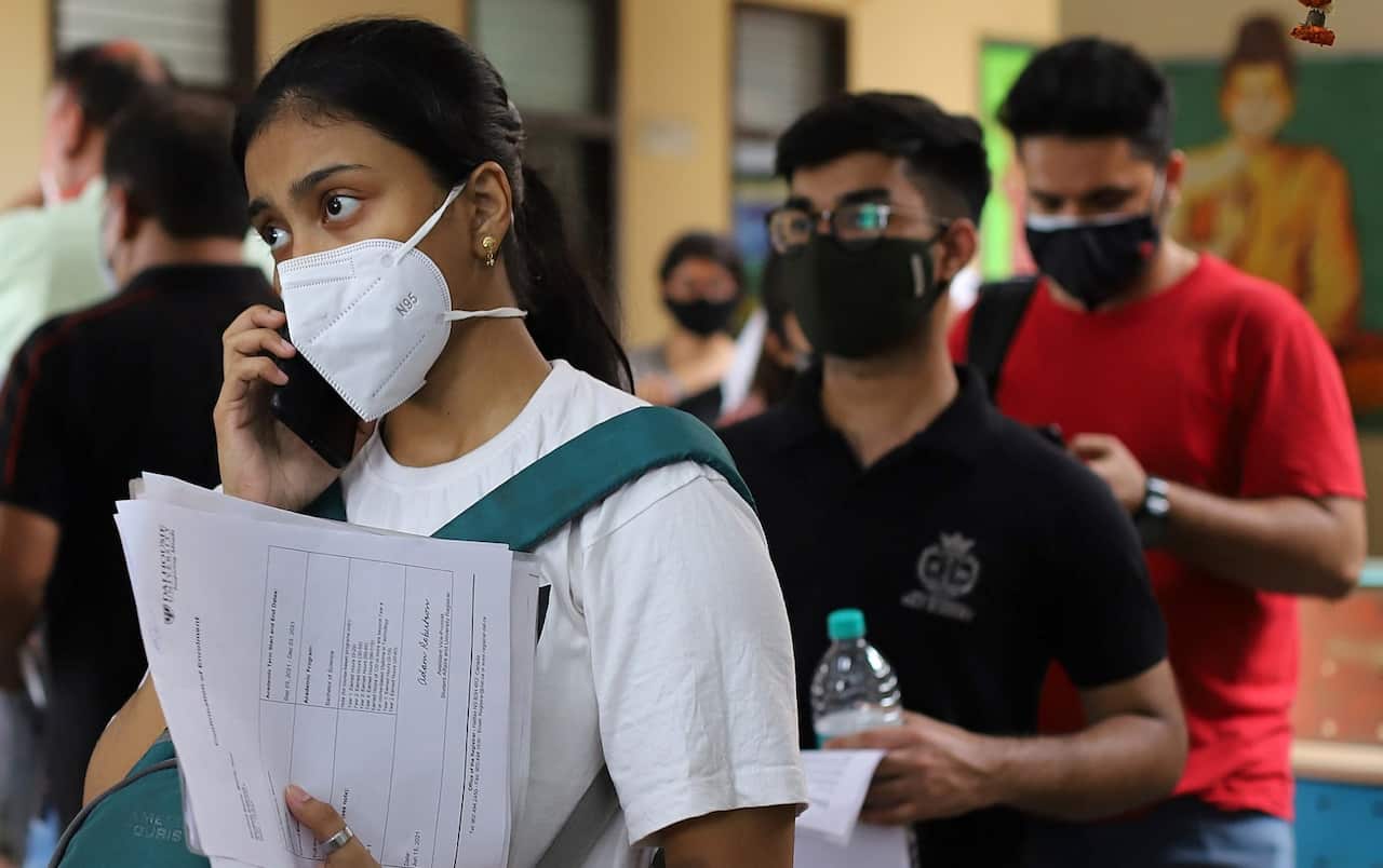 Students and international travellers line up to  complete paperwork in New Delhi. (file)
