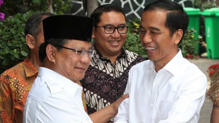 Indonesia's President-elect Joko Widodo, right, greets his political rival Prabowo Subianto during a meeting in Jakarta, Indonesia. 