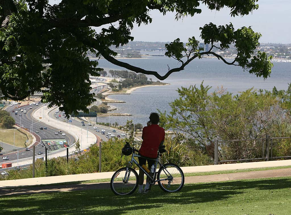 A man rests on his bike (C-below), as he