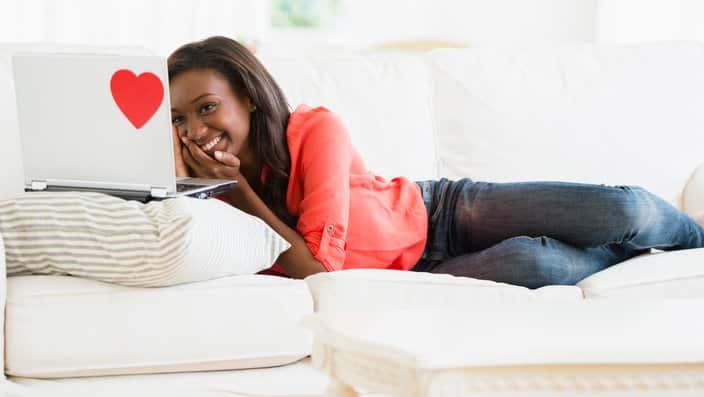 A woman using laptop on sofa