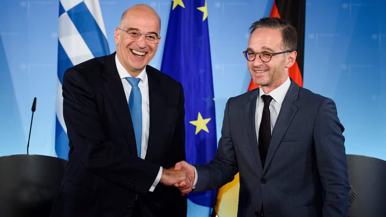 German Foreign Minister Heiko Maas, right, and Nikos Dendias, Foreign Minister of Greece, shake hands after a news conference in Berlin, Germany, Monday, Sept, 16, 2019. (Gregor Fischer/dpa via AP)