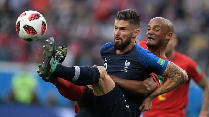 France's forward Olivier Giroud (L) vies for the ball with Belgium's defender Vincent Kompany during the Russia 2018 World Cup.