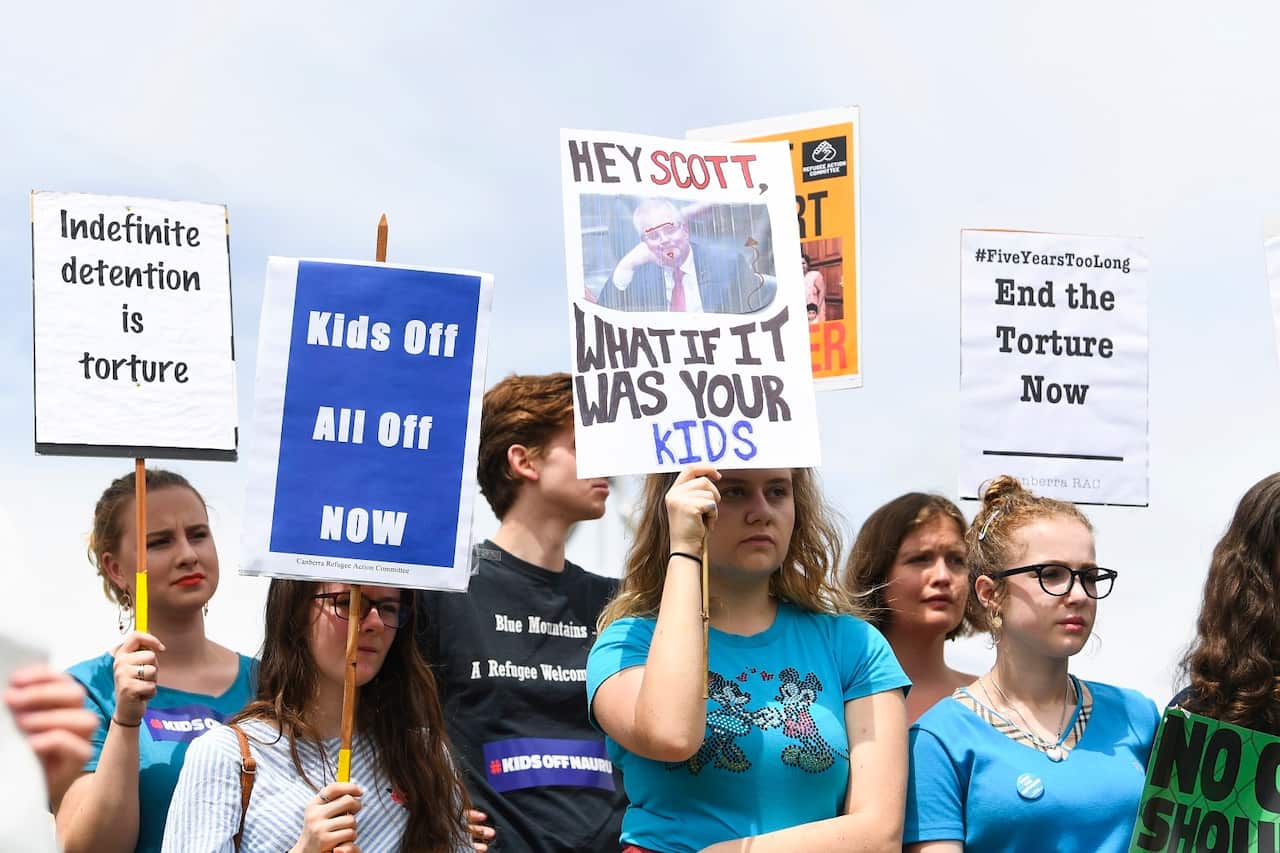 Protesters demand the resettlement of children held on Nauru, outside Parliament House in Canberra on 27 November.