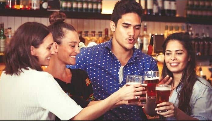 Young people enjoying a drink at a pub