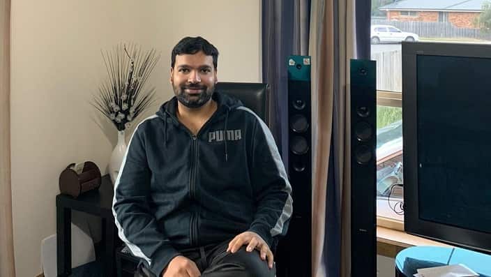 Nurse Qasim Mehmood at his home in Hobart during self-isolation.