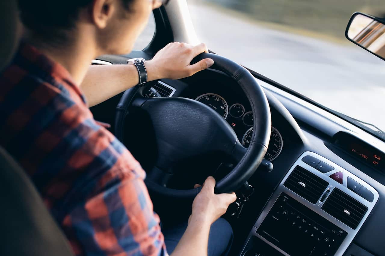 Can I continue to drive my car after the yellow engine fault light comes on?