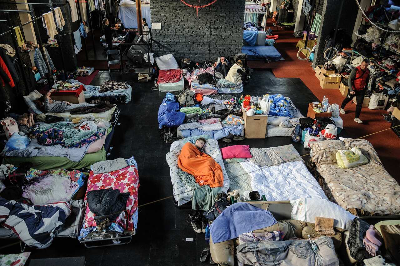 People seen at a gym converted for accommodation for refugees from the Russian military aggression in Ukraine. (Photo by Mykola Tys / SOPA Images/Sipa USA)