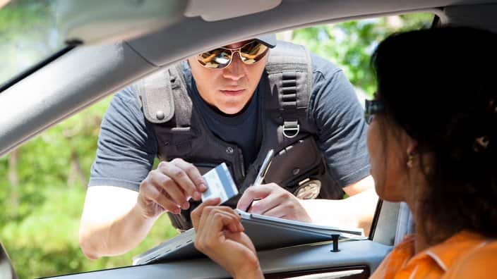 Crime: Policeman gives driver a traffic ticket.