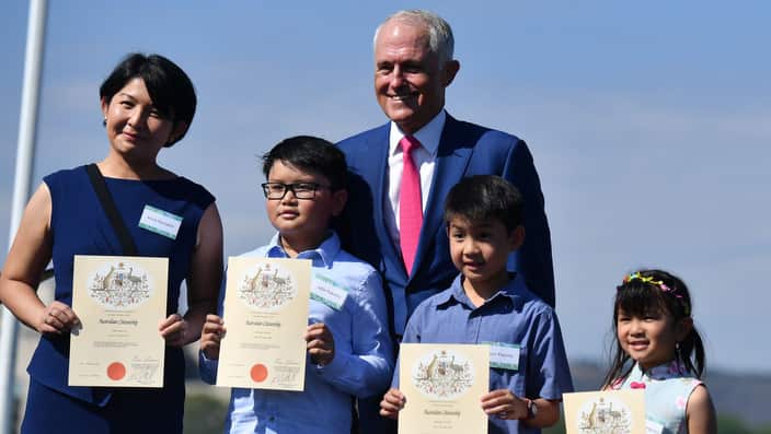 Prime Minister Malcolm Turnbull poses with new Australian citizens at an Australia Day Citizenship Ceremony and Flag Raising event in Canberra, Friday, January 26, 2018. (AAP Image/Mick Tsikas) NO ARCHIVING