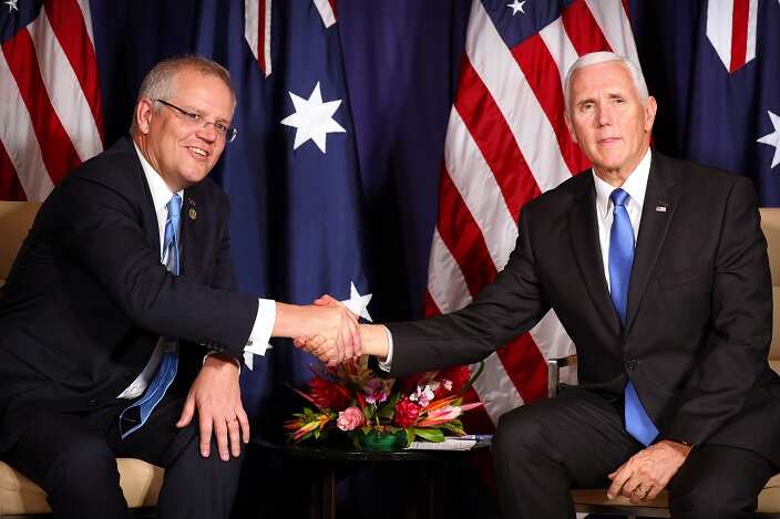 Australian Prime Minster Scott Morrison (L) and US Vice President Mike Pence (R) shake hands during a bilateral meeting on the sidelines of the APEC Summit