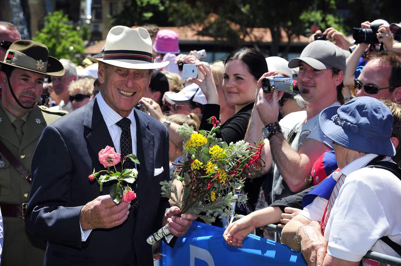 Prince Philip holding flowers as he greets the public during the Great Aussie Barbecue in Perth.