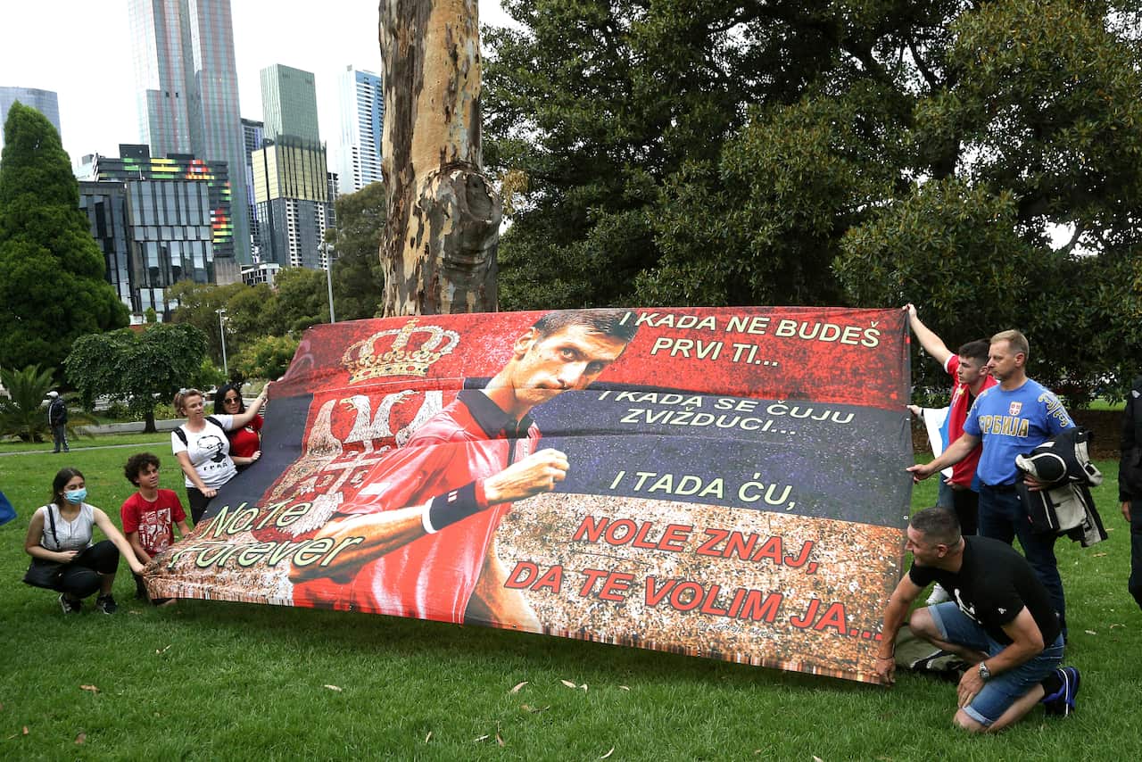 Protestors outside the Park Hotel in the Melbourne suburb of Carlton ahead of the Australian Open in Melbourne where it is believed Serbia Novak Djokovic is currently being detained, Australia, Friday, Jan. 7, 2022. Djokovic had received the medical exemp