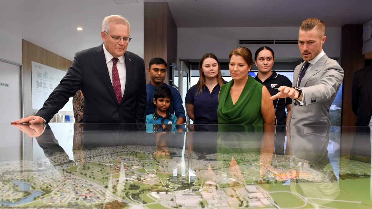 Prime Minister Scott Morrison, wife Jenny and Liberal candidate for Blair Sam Biggins at Springfield Rise Display Village on Day 36 of the 2022 federal election campaign, in Springfield, 25km south of Brisbane, in the seat of Blair. Monday, May 16, 2022. 