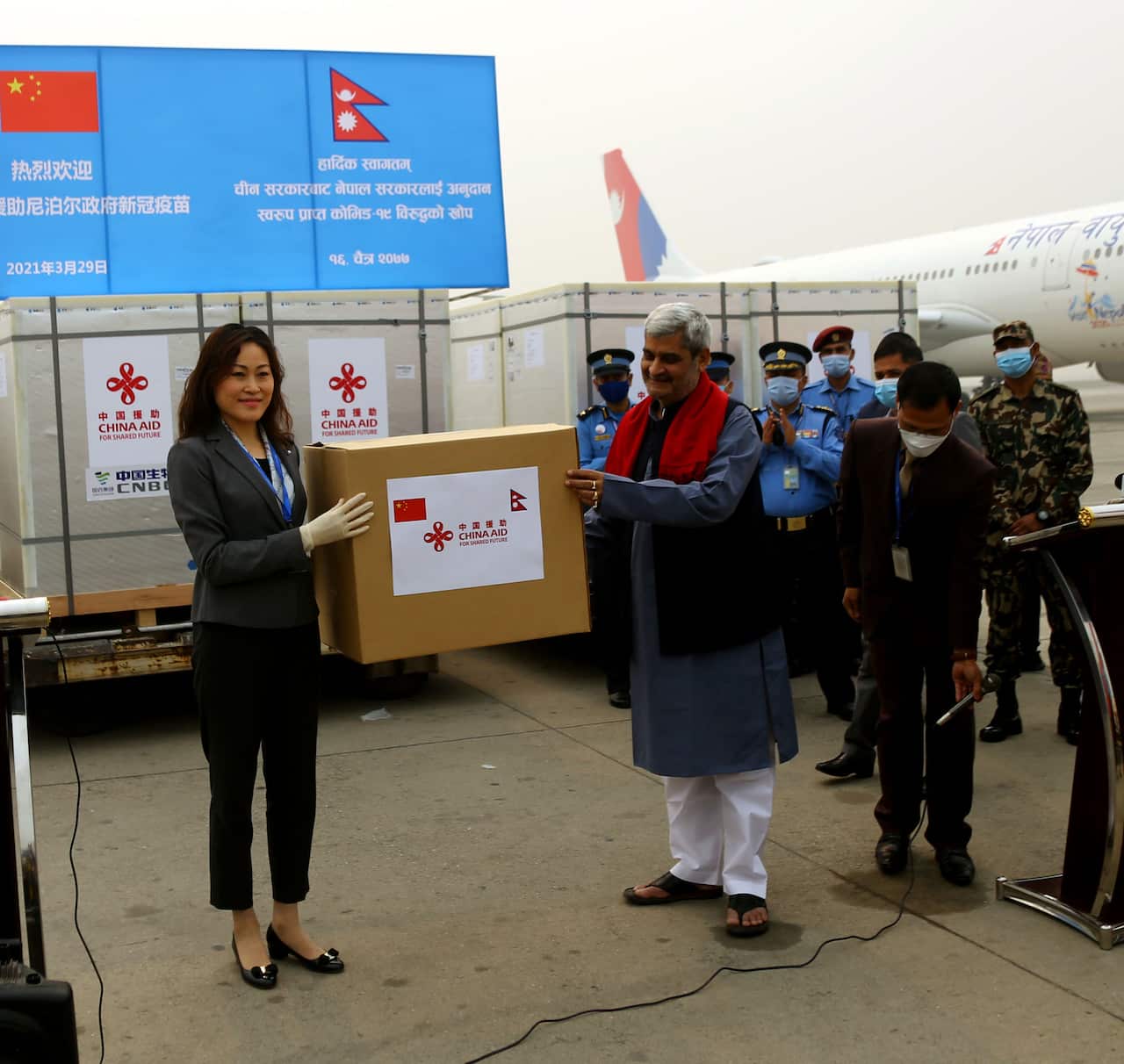 Chinese ambassador Hou Yanqi handing over 8 lakh doses of  doses of COVID-19 vaccines to Nepal on Monday.