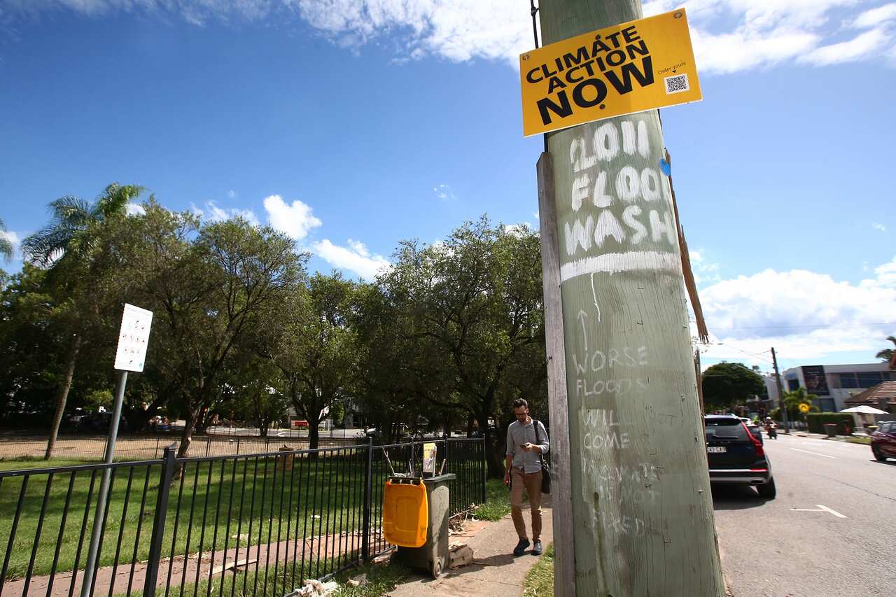 environment, business, politics A climate change sign is seen in Milton, Brisbane, Monday, March 7, 2022. Queensland, federal elections