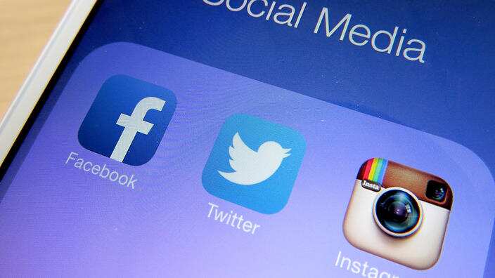 General view of social media apps Facebook, Twitter and Instagram displayed on an iPhone 5.