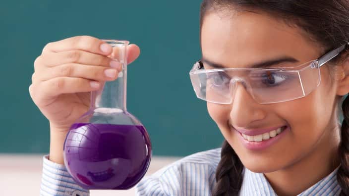 Teenage Girls doing experiment in laboratory
