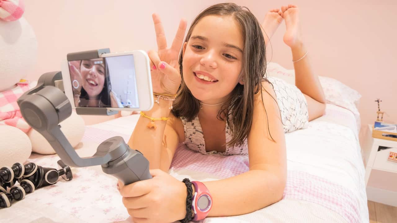 Young girl recording video to put on social media
