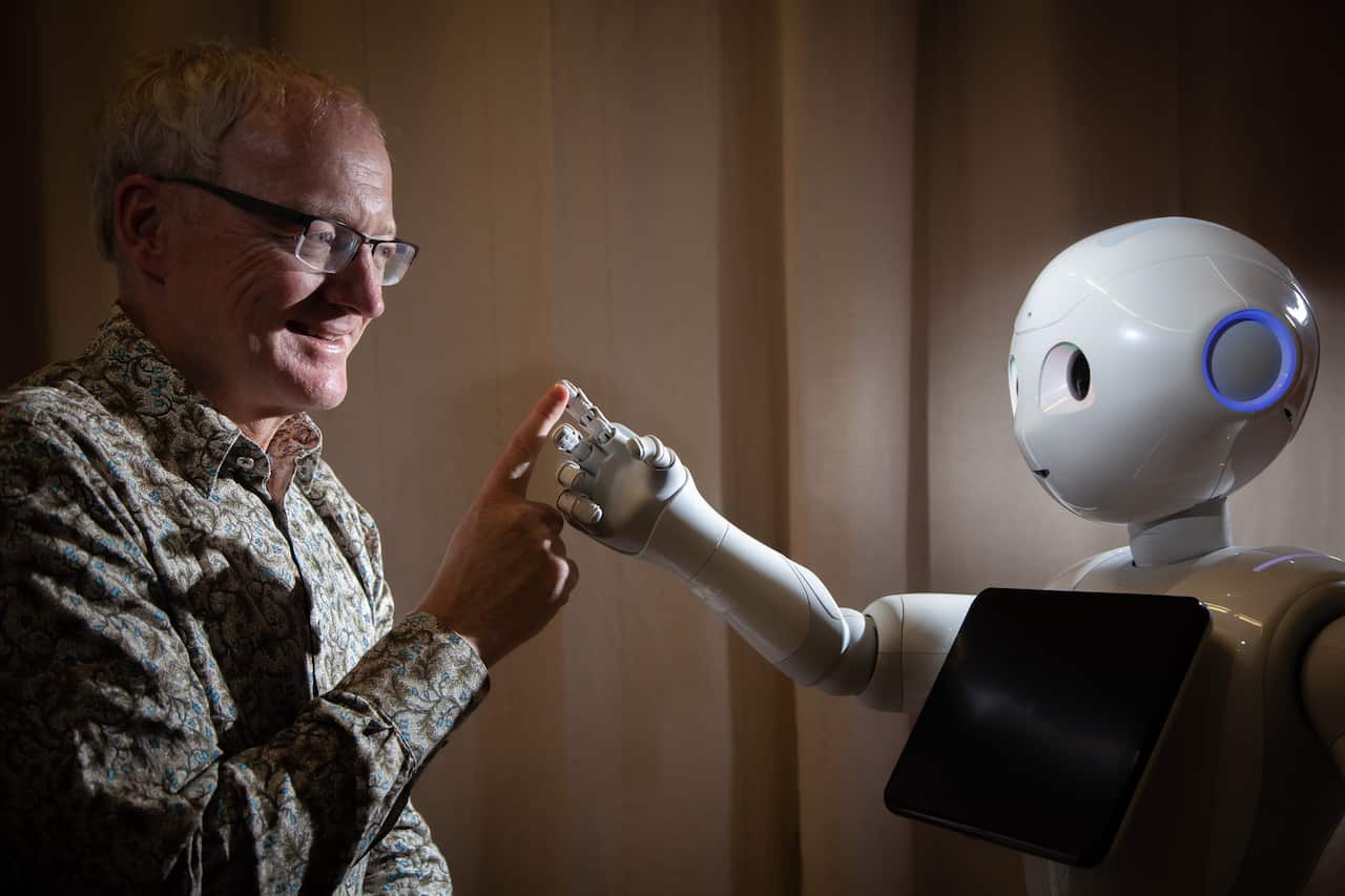 Prof.Toby Walsh with a Pepper robot