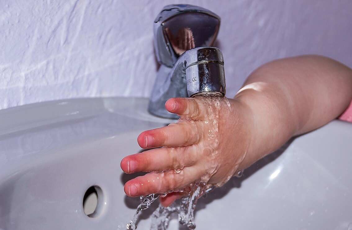 toddler trying to do hand washing