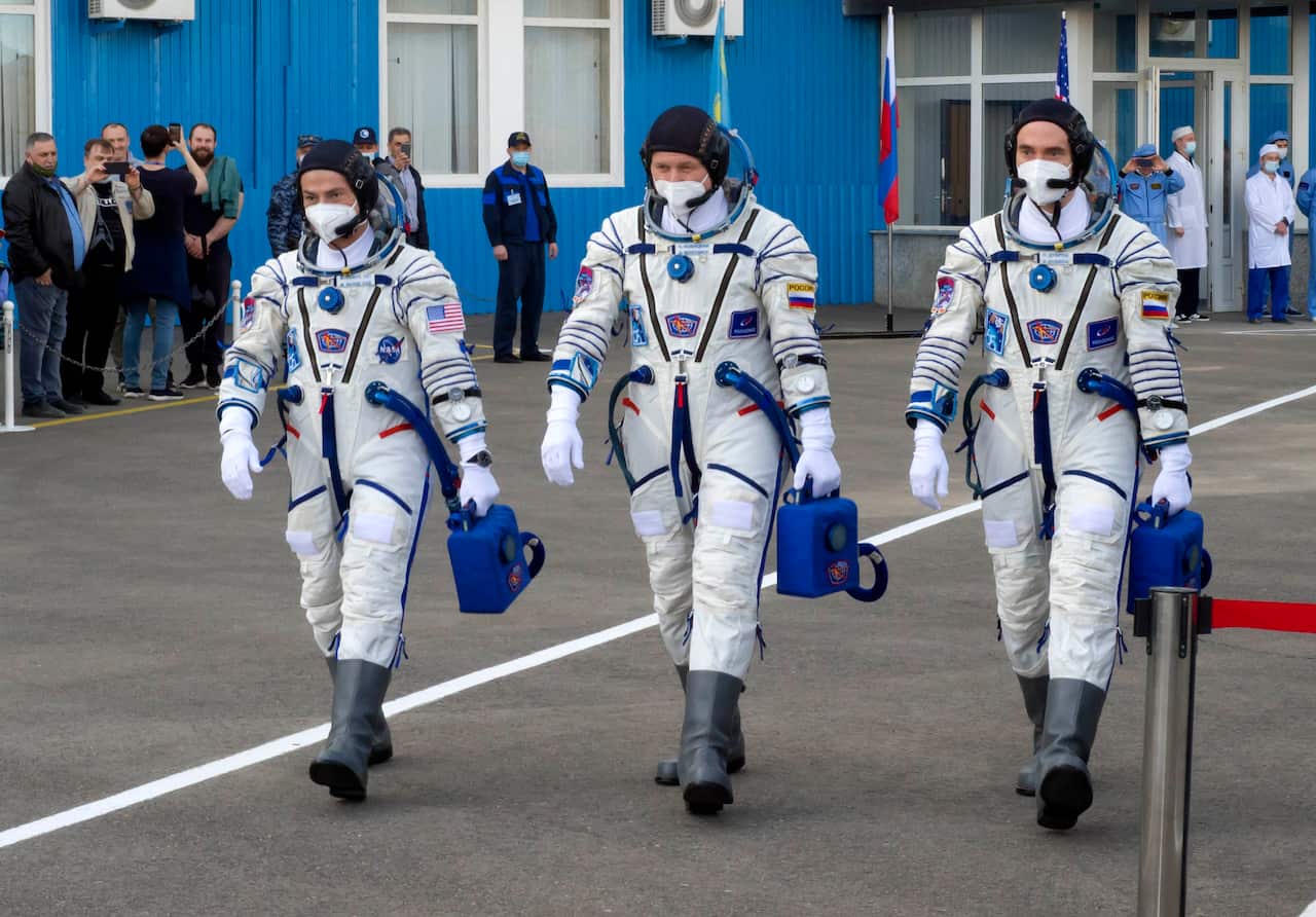 US astronaut Mark Vande Hei and Russian cosmonauts Oleg Novitsky and Pyotr Dubrov, walk prior to the launch at the Baikonur cosmodrome.