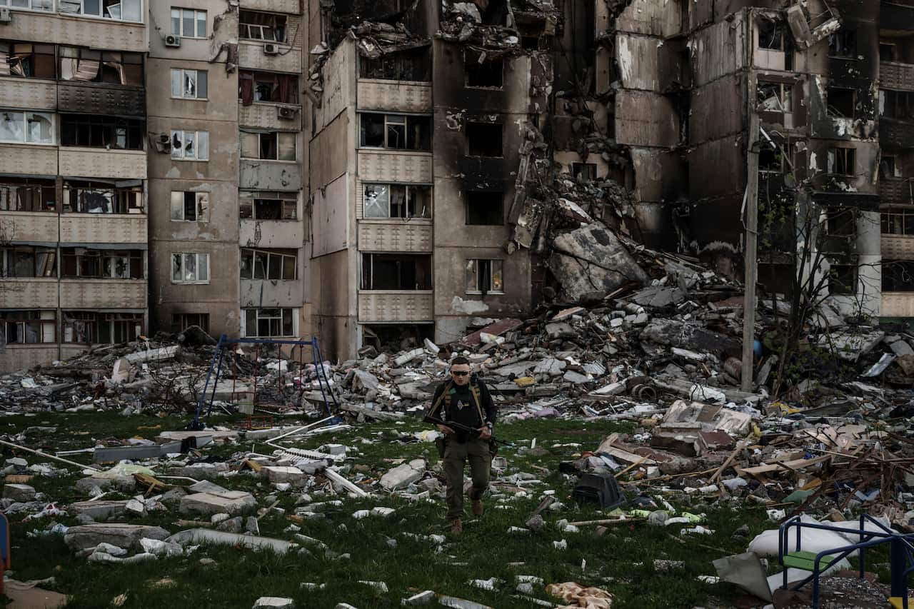 A Ukrainian serviceman walks amid the rubble of a building heavily damaged by multiple Russian bombardments near a frontline in Kharkiv, Ukraine, Monday, April 25, 2022. (AP Photo/Felipe Dana)