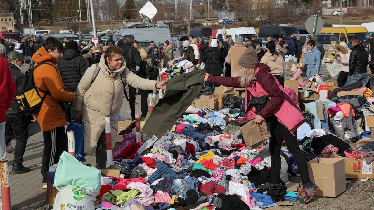 Ukranian refugees offered warm clothes as they arrive at the Medyka border crossing, Poland, Saturday, Feb. 26, 2022