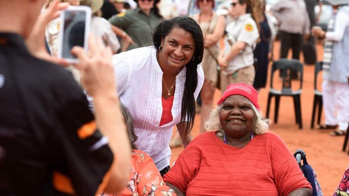 Northern Territory Senator Nova Peris with a Aboriginal woman during an event to mark the 30th anniversary of the hand back of Uluru at Mutitjulu community.