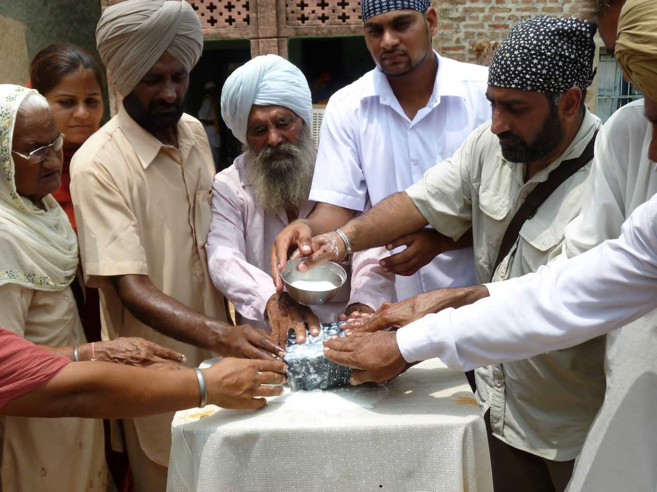 Pooran Singh's family members perform the last rites before the ashes are taken to Haridwar for immersion in the Ganga river