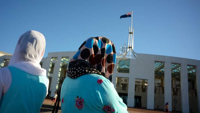 Visitors of Afghan nationality outside Parliament House in Canberra 