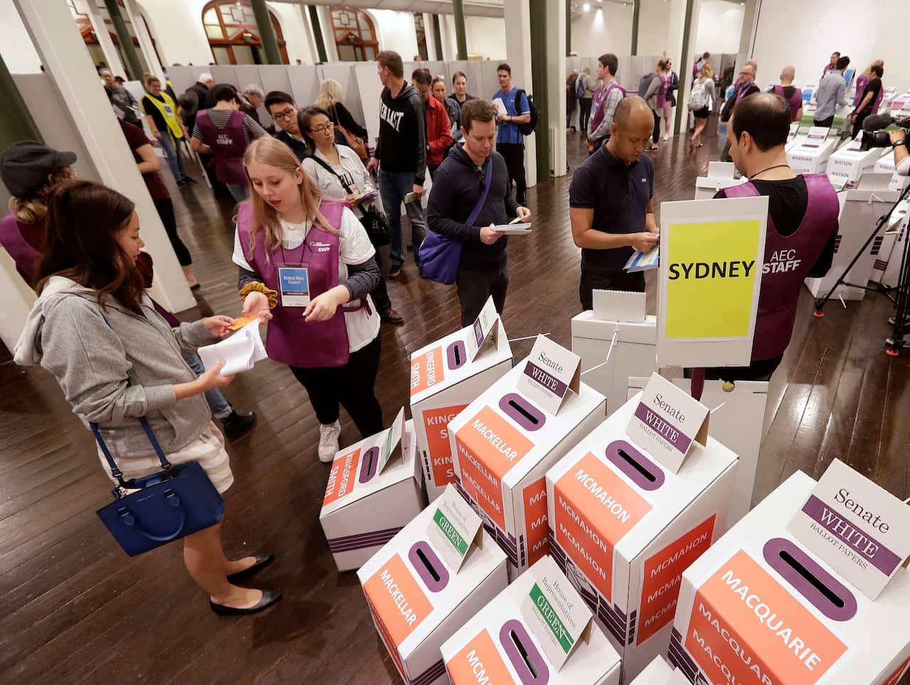 Voters cast their ballots at the Town Hall in Sydney, Australia, in a federal election, Saturday, May 18, 2019.