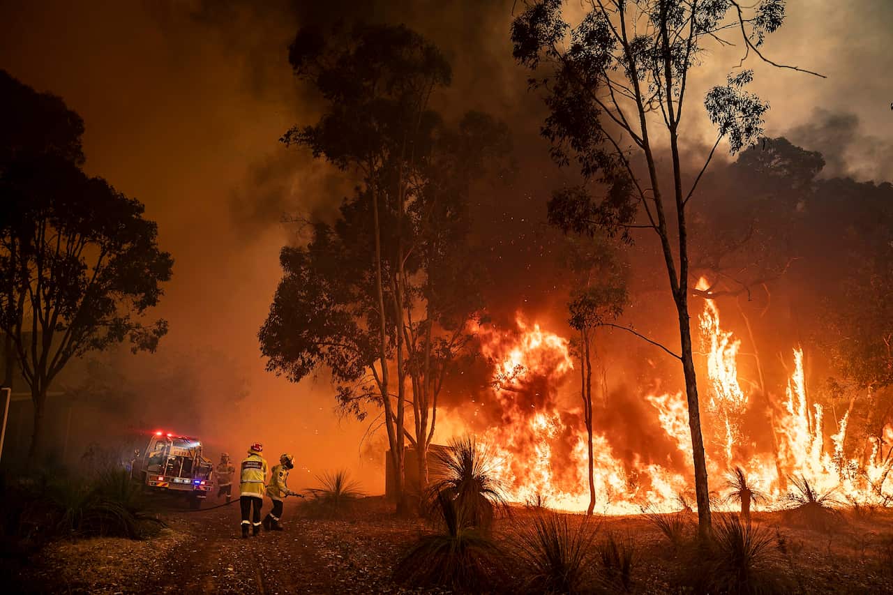 A supplied image obtained on Monday, December 27, 2021, of Fire fighters in Western Australia battling a blaze at Chidlow and Wooroloo Bushfire, WA (AAP Image/Supplied by DFES, Evan Collis) NO ARCHIVING, EDITORIAL USE ONLY