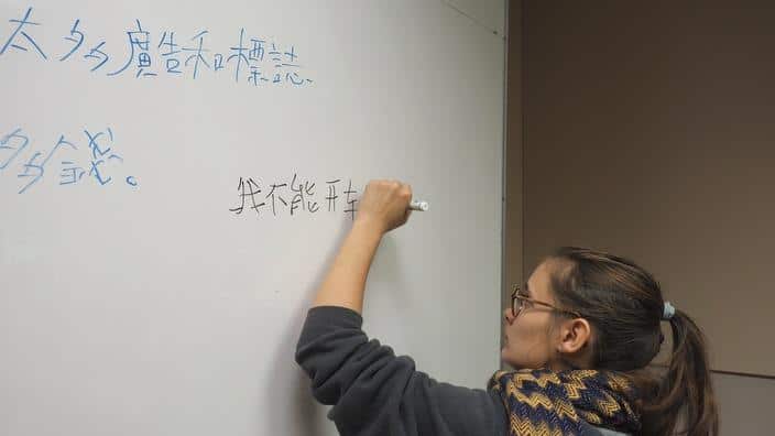 A student writes Chinese characters (AAP)