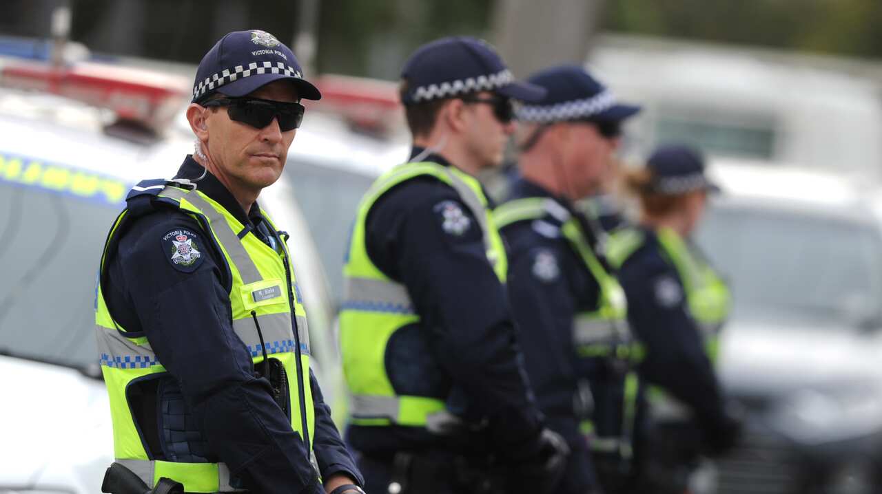 Police stand guard outside a Hells Angels fortified club house in Melbourne, Thursday, Oct. 10, 2013. Victoria Police today executed a number of raids on bikie clubhouses across Victoria. (AAP Image/Julian Smith) NO ARCHIVING