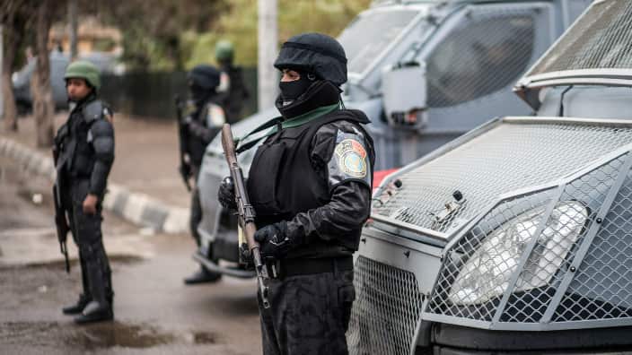 Policemen stand guard as they patrol a street on Police Day