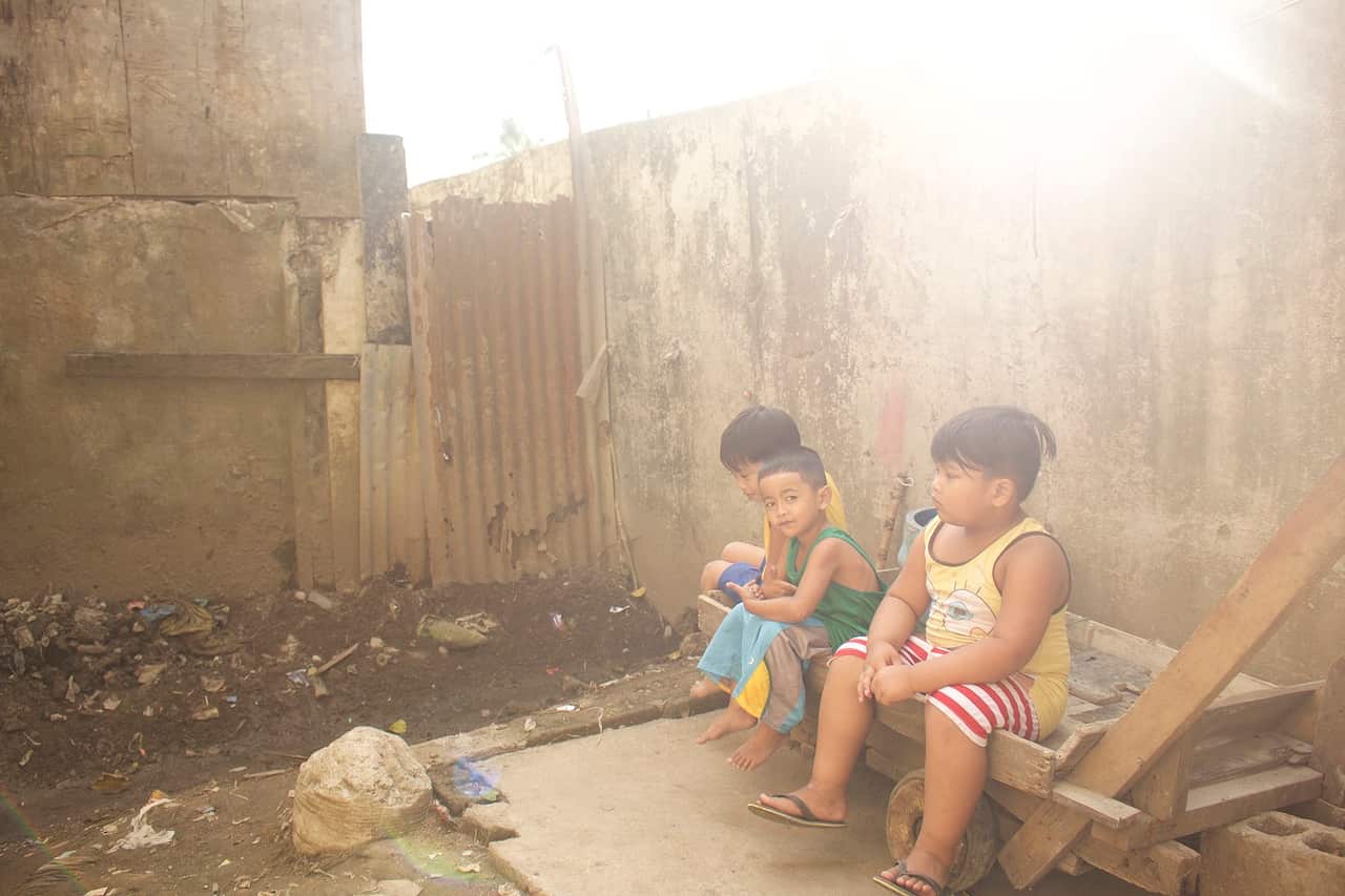 Children sit beside the area where Kian's body was found